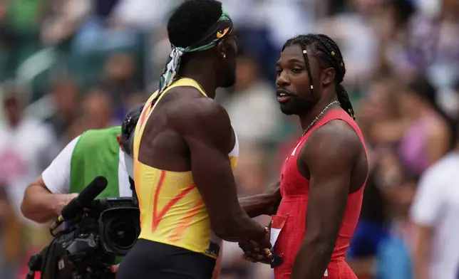 Noah Lyles and Kenny Bednarek shake hands after the men's 200-meter final at the U.S. Championships athletics meet in Eugene, Ore., Sunday, Aug. 3, 2025. (AP Photo/Abbie Parr)