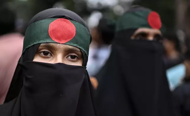 Women supporters of National Citizen Party (NCP) wear headbands in the colors of the Bangladeshi national flag during a political rally in Dhaka, Bangladesh, Sunday, Aug. 3, 2025. (AP Photo/Mahmud Hossain Opu)