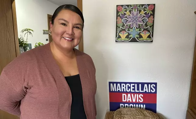 North Dakota Democratic Rep. Jayme Davis poses for a photo in her office with a 2024 campaign sign on Wednesday, July 23, 2025, at Turtle Mountain Administrative Offices on the Turtle Mountain Reservation in North Dakota. (AP Photo/Jack Dura)
