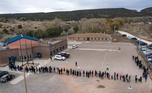 FILE - Voters wait in line to cast their ballots outside a polling station on the Navajo Nation in Fort Defiance, Ariz., on Election Day, Nov. 5, 2024. (AP Photo/Andres Leighton, File)