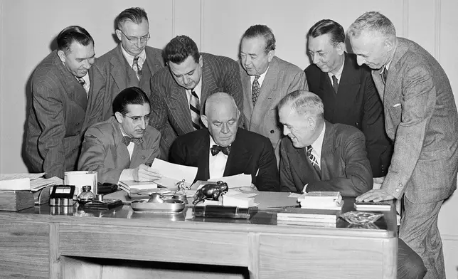 FILE - A group of sportswriters confer with Grantland Rice, noted sports authority, seated at center, in Chicago, Nov. 13, 1949, to select Look Magazine's All-America college football team. Seated, from left: Hal Middlesworth, Daily Oklahoman; Rice; and Bert McGrane, Des Moines Register. Standing from left: Raymond Johnson, Nashville Tennessean; Francis Powers, Chicago Daily News; Tim Cohane, Look Magazine; Charley Johnson, Minneapolis Star; Bill Leiser, San Francisco Chronicle, and HG. Salsinger, Detroit News. (AP Photo/Paul Cannon, File)