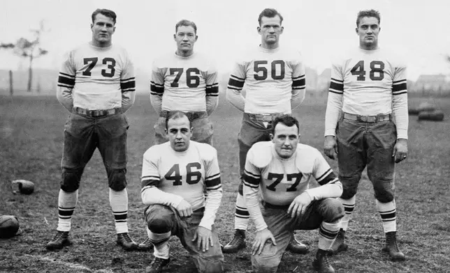 Six outstanding stars on Coach Hanley's squad that will represent the East in the East-West Game at San Francisco on New Year's Day pose Dec. 17, 1929. They are, standing from left, Bronko Nagurski, Minnesota; Tony Holm, Alabama; Elmer Sleight, Purdue, Ted Twomey, Notre Dame: kneeling from left, Willis Glasgow, Iowa; and Jack Cannon, Notre Dame. (AP Photo/File)