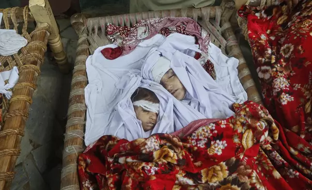 EDS NOTE: GRAPHIC CONTENT - Bodies of children, killed in Friday's flash flooding, seen at a house at a village near Pir Baba, Buner district, in Pakistan's northwest, Saturday, Aug.16, 2025. (AP Photo/Muhammad Sajjad)