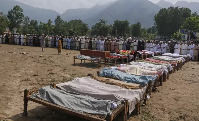 People attend funeral prayers for the victims of Friday's flash flooding, at a village near Pir Baba, Buner district, in Pakistan's northwest, Saturday, Aug.16, 2025. (AP Photo/Muhammad Sajjad)