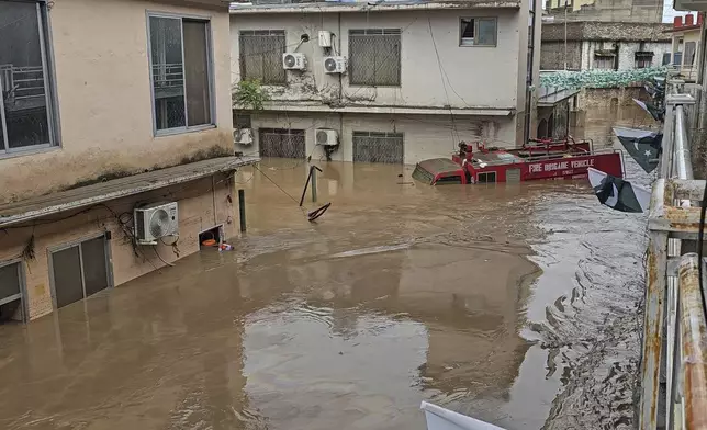 A firefighting department vehicle submerged in a floodwater following flash flooding due to heavy rains in the neighbourhood of Mingora, the main town of Swat Valley, northwestern Pakistan, Friday, Aug. 15, 2025. (AP Photo/Sherin Zada)