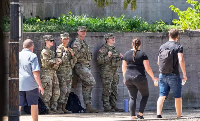 National Guard soldiers stand outside the Smithsonian Air and Space Museum on the National Mall in Washington, as part of President Donald Trump's order to use federal law enforcement to expel homeless people and rid the nation's capital of violent crime, Monday, Aug. 25, 2025. (AP Photo/J. Scott Applewhite)