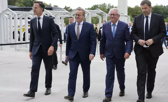 NATO Secretary General Mark Rutte, from left, German Defense Minister Boris Pistorius, CEO Armin Papperger and German Vice Chancellor Lars Klingbeil arrive for the inauguration of the newly built artillery ammunition plant by German arms manufacturer Rheinmetall in Unterluess, Germany, Wednesday, Aug. 27, 2025. (AP Photo/Markus Schreiber)