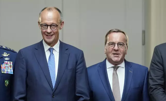 German Chancellor Friedrich Merz, left, and German Defense Minister Boris Pistorius pose for a group picture prior to the Cabinet meeting at the Defense Ministry in Berlin, Germany, Wednesday, Aug. 27, 2025. (AP Photo/Ebrahim Noroozi)