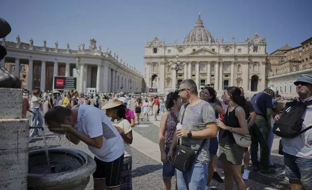 People refresh at a fountain in St.Peter's Square, at the Vatican, Sunday, Aug. 10, 2025. (AP Photo/Andrew Medichini)