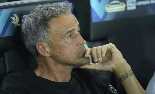 PSG's coach Luis Enrique sits before the UEFA Super Cup soccer match between Paris Saint-Germain and Tottenham Hotspur in Udine, Italy, Wednesday, Aug. 13, 2025. (AP Photo/Darko Bandic)