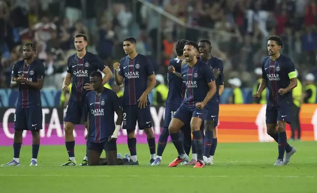 PSG's players react during the penalty shootout at the UEFA Super Cup soccer match between Paris Saint-Germain and Tottenham Hotspur in Udine, Italy, Wednesday, Aug. 13, 2025. (AP Photo/Antonio Calanni)