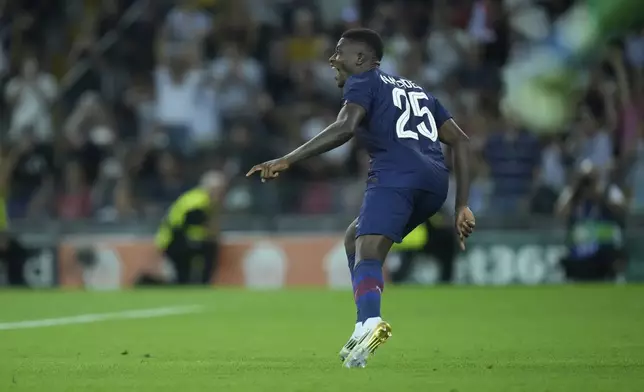 PSG's Nuno Mendes reacts during the penalty shootout the UEFA Super Cup soccer match between Paris Saint-Germain and Tottenham Hotspur in Udine, Italy, Wednesday, Aug. 13, 2025. (AP Photo/Darko Bandic)