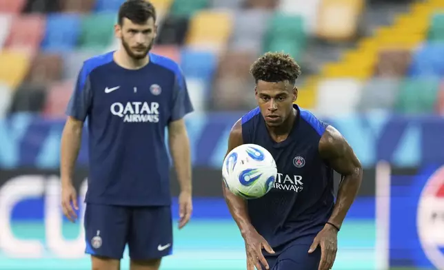 PSG's Desire Doue prepares to take a shot during a training session in Udine, Tuesday, Aug. 12, 2025 ahead of Wednesday's UEFA Super Cup soccer match between Paris Saint-Germain and Tottenham Hotspur. (AP Photo/Darko Bandic)