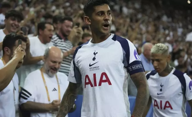 Tottenham's Cristian Romero celebrates after scoring his side's second goal during the UEFA Super Cup soccer match between Paris Saint-Germain and Tottenham Hotspur in Udine, Italy, Wednesday, Aug. 13, 2025. (AP Photo/Antonio Calanni)