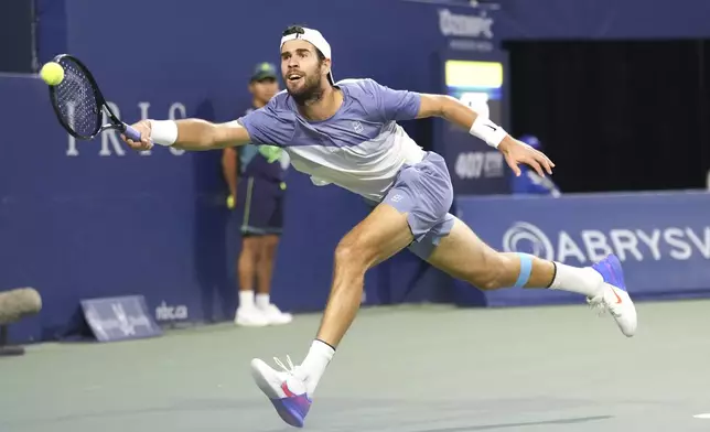 Karen Khachanov, of Russia, returns to Ben Shelton, of the United States, during the men's final at the National Bank Open tennis tournament in Toronto, Thursday, Aug. 7, 2025. (Chris Young/The Canadian Press via AP)