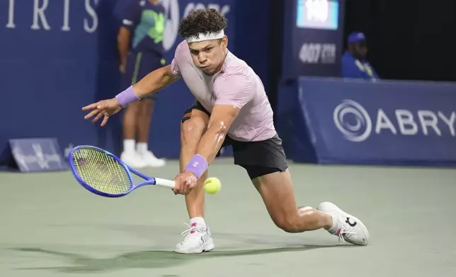 Ben Shelton, of the United States, hits a return to Karen Khachanov, of Russia, during the men's final at the National Bank Open tennis tournament in Toronto, Thursday, Aug. 7, 2025. (Chris Young/The Canadian Press via AP)