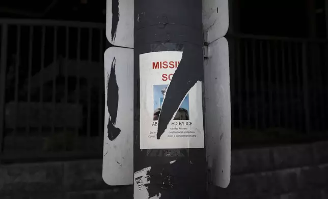 A torn missing person flyer, for an immigrant believed to be detained by ICE, is posted on a pole in Los Angeles, Saturday, July 19, 2025. (AP Photo/Jae C. Hong)