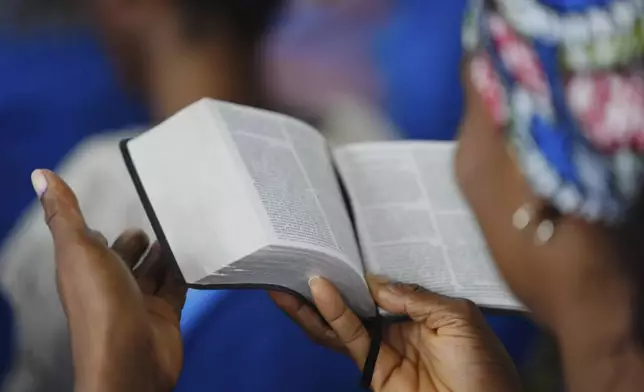 A woman reads the bible during a church service at the Christian Mission for the Deaf in Lagos, Nigeria, Sunday, July 13, 2025. (AP Photo/Sunday Alamba)