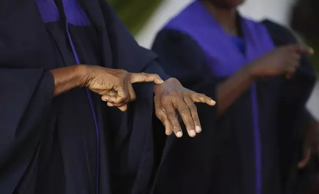 A member of the choir uses sign language during a church service at the Christian Mission for the Deaf in Lagos, Nigeria, Sunday, July 13, 2025. (AP Photo/Sunday Alamba)