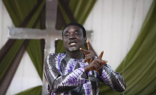 Remi Akinremi, a pastor, preaches using sign language during a church service at the Christian Mission for the Deaf in Lagos, Nigeria, Sunday, July 13, 2025. (AP Photo/Sunday Alamba)