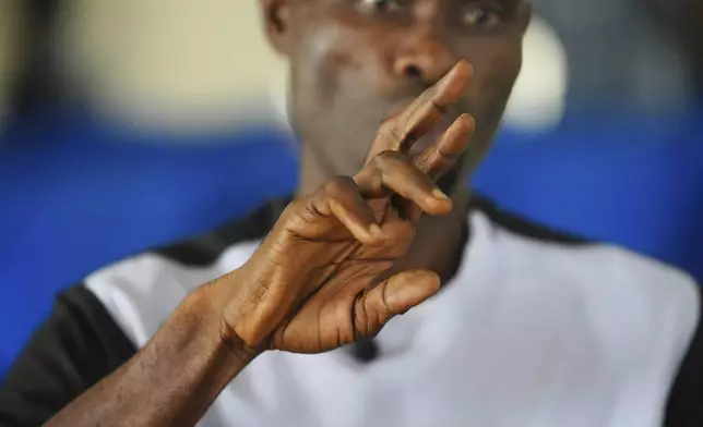 Imoh Udoka, a pastor, preaches using sign language during a church service at the Christian Mission for the Deaf in Lagos, Nigeria, Sunday, July 13, 2025. (AP Photo/Sunday Alamba)