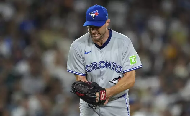 Toronto Blue Jays starting pitcher Max Scherzer celebrates after striking out Los Angeles Dodgers' Andy Pages to end the sixth inning of a baseball game Friday, Aug. 8, 2025, in Los Angeles. (AP Photo/Mark J. Terrill)