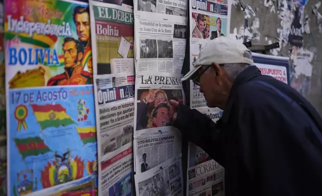 A man looks at newspapers front pages the day after presidential and legislative elections in La Paz, Bolivia, Monday, Aug. 18, 2025. (AP Photo/Juan Karita)