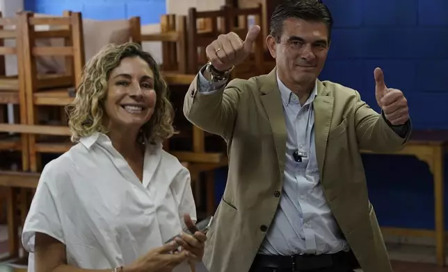 Presidential candidate Rodrigo Paz and his wife Maria Elena Urquidi pose as they accompany their daughter Catalina to vote during general elections in La Paz, Bolivia, Sunday, Aug. 17, 2025. (AP Photo/Freddy Barragan)