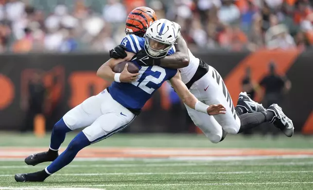 Indianapolis Colts quarterback Jason Bean (12) is sacked by Cincinnati Bengals' Isaiah Thomas during the second half of a preseason NFL football game, Saturday, Aug. 23, 2025, in Cincinnati. (AP Photo/Carolyn Kaster)