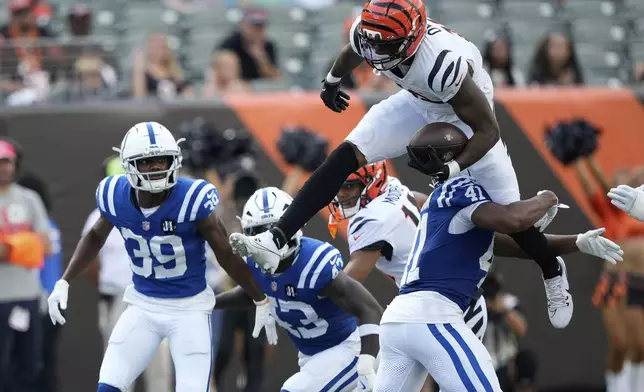 Cincinnati Bengals' Rashod Owens (12) leaps against Indianapolis Colts safety Trey Washington (41)during the second half of a preseason NFL football game, Saturday, Aug. 23, 2025, in Cincinnati. (AP Photo/Carolyn Kaster)