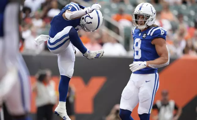 Indianapolis Colts wide receiver Coleman Owen celebrates a touchdown catch in front of wide receiver Landon Parker (8) during the second half of a preseason NFL football game, Saturday, Aug. 23, 2025, in Cincinnati. (AP Photo/Carolyn Kaster)