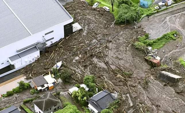 A residential area is coverd with debris forlloing a heavy rain in Kirishima, Kagoshima prefecture, southern Japan Friday, Aug. 8, 2025. (Kyodo News via AP)