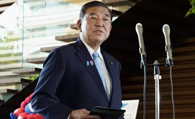 Japan's Prime Minister Shigeru Ishiba speaks to reporters at his office in Tokyo Friday, Aug. 8, 2025, as officials issued hightest-level warnings of heavy rain in southern Japan. (Keisuke Hosojima/Kyodo News via AP)