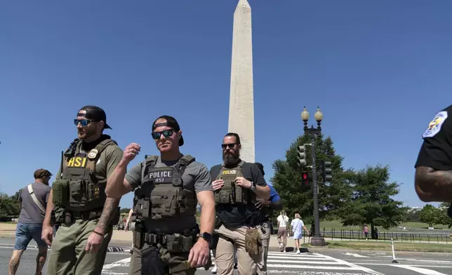 Homeland Security Investigations (HSI) agents patrol the National Mall, Saturday, Aug. 23, 2025, in Washington. (AP Photo/Jose Luis Magana)