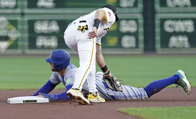 Toronto Blue Jays' George Springer, bottom, steals second as Pittsburgh Pirates shortstop Jared Triolo, top, applies the late tag during the first inning of a baseball game Tuesday, Aug. 19, 2025, in Pittsburgh. (AP Photo/Matt Freed)