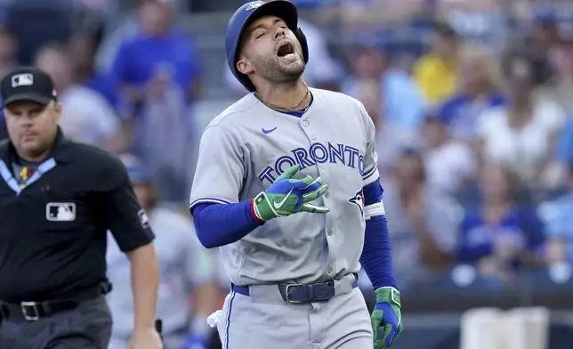Toronto Blue Jays' George Springer reacts after getting hit by a pitch during the first inning of a baseball game against the Pittsburgh Pirates Tuesday, Aug. 19, 2025, in Pittsburgh. (AP Photo/Matt Freed)