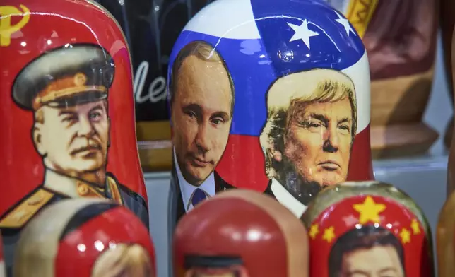 Traditional Russian wooden dolls called Matryoshka depicting Soviet Leader Josef Stalin, left, Russian President Vladimir Putin, center, and U.S. President Donald Trump are displayed for sale at a souvenir shop in Moscow, Russia, Tuesday, Aug. 12, 2025. (AP Photo/Alexander Zemlianichenko)