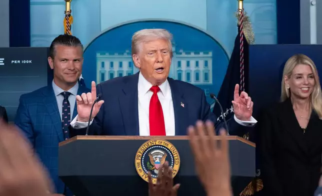 President Donald Trump speaks with reporters in the James Brady Press Briefing Room at the White House, Monday, Aug. 11, 2025, in Washington, as Secretary of Defense Pete Hegseth and Attorney General Pam Bondi look on. (AP Photo/Alex Brandon)