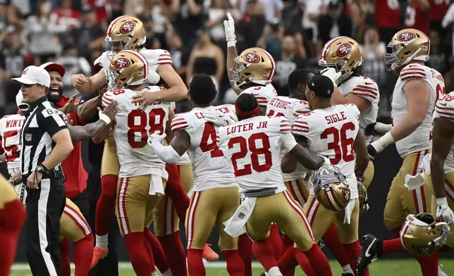 San Francisco 49ers place kicker Jake Moody, top left, is lifted by teammates after making the game-winning field goal during a preseason NFL football game against the Las Vegas Raiders, Saturday, Aug. 16, 2025, in Las Vegas. (AP Photo/David Becker)