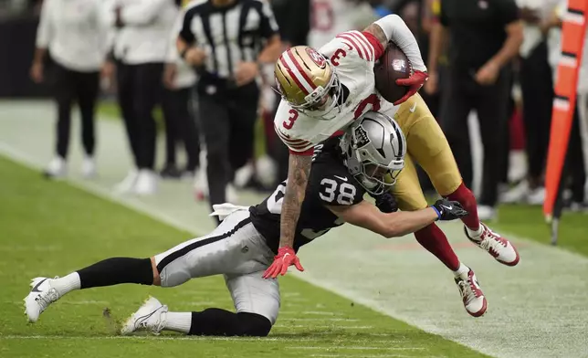 San Francisco 49ers wide receiver Robbie Chosen (3) is tackled by Las Vegas Raiders safety Hudson Clark (38) during the second half of a preseason NFL football game Saturday, Aug. 16, 2025, in Las Vegas. (AP Photo/John Locher)