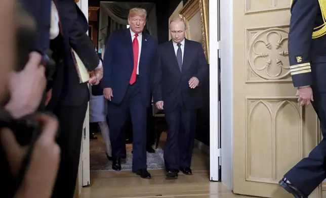 FILE - President Donald Trump, left, and Russian President Vladimir Putin, right, arrive for a one-on-one-meeting at the Presidential Palace in Helsinki, Finland, July 16, 2018. (AP Photo/Pablo Martinez Monsivais, File)