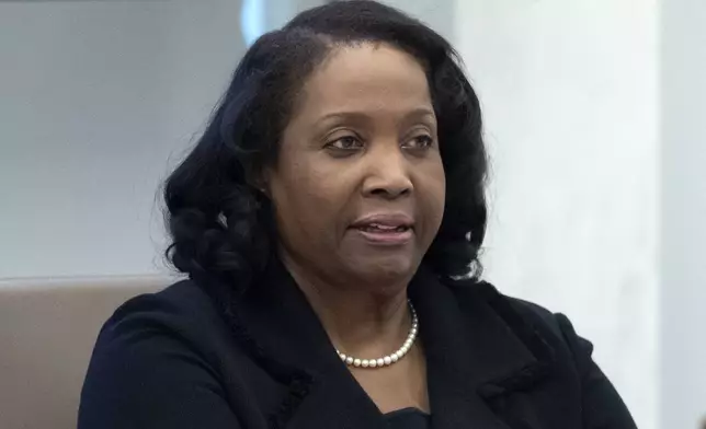FILE - Federal Reserve Board of Governors member Lisa Cook listens during an open meeting of the Board of Governors at the Federal Reserve, June 25, 2025, in Washington. (AP Photo/Mark Schiefelbein, File)