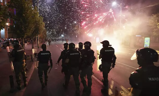 Serbian gendarmerie officers guard street during an anti-government protest near Serbian Progressive Party office in Belgrade, Serbia, Thursday, Aug. 14, 2025. (AP Photo/Darko Vojinovic)