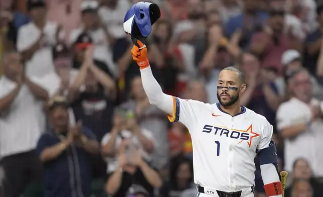 Houston Astros' Carlos Correa acknowledges the crowd as he come up to bat against the Boston Red Sox during the first inning of a baseball game Monday, Aug. 11, 2025, in Houston. (AP Photo/David J. Phillip)