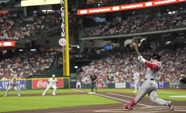 Boston Red Sox's Alex Bregman hits a two-run home run against the Houston Astros during the first inning of a baseball game Monday, Aug. 11, 2025, in Houston. (AP Photo/David J. Phillip)