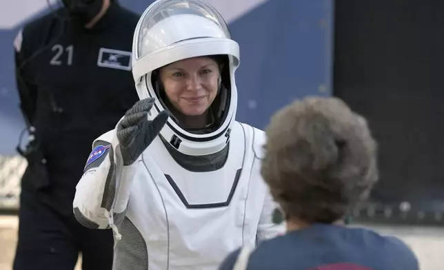 Astronaut Zena Cardman waves as she leaves the Operations and Checkout Building for a trip the Kennedy Space Center's Launch Pad 39-A and a planned liftoff on a SpaceX Falcon 9 rocket Friday, Aug. 1, 2025, in Cape Canaveral , Fla. (AP Photo/John Raoux)
