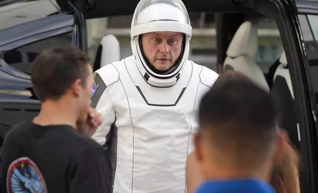 Astronaut Mike Fincke speaks to friends as he leaves the Operations and Checkout Building for a trip the Kennedy Space Center's Launch Pad 39-A and a planned liftoff on a SpaceX Falcon 9 rocket Friday, Aug. 1, 2025, in Cape Canaveral , Fla. (AP Photo/John Raoux)