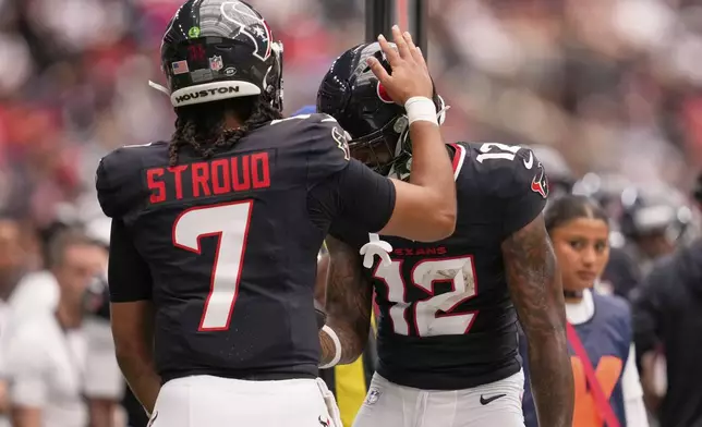 Houston Texans wide receiver Nico Collins celebrates after scoring with quarterback C.J. Stroud against the Carolina Panthers during the first half of an NFL preseason football game on Saturday, Aug. 16, 2025, in Houston. (AP Photo/Ashley Landis)