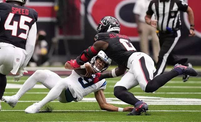 Carolina Panthers quarterback Bryce Young is tackled by Houston Texans linebacker Azeez Al-Shaair during the first half of an NFL preseason football game on Saturday, Aug. 16, 2025, in Houston. (AP Photo/David J. Phillip)
