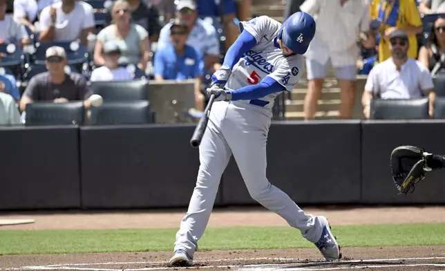 Los Angeles Dodgers' Freddie Freeman doubles during the first inning of a baseball game against the Tampa Bay Rays, Sunday, Aug. 3, 2025, in Tampa, Fla. (AP Photo/Jason Behnken)